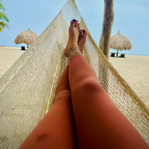 Resting in a hammock with the ocean in the distance. Chandra Vida Retreats.