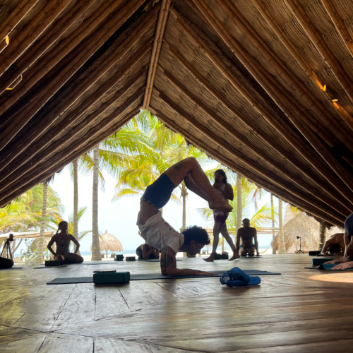 Caro demonstrates scorpion pose in the yoga shala. Chandra Vida Retreats.