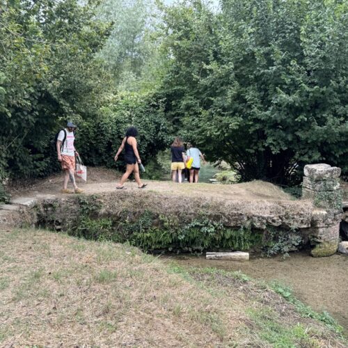 Students crossing a bridge to get to the springs in tuscany. Chandra Vida Retreats.