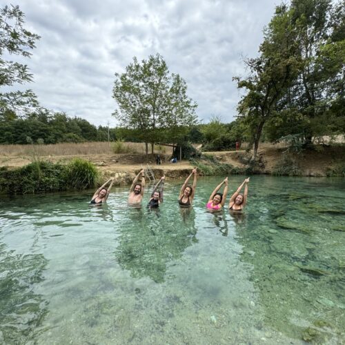 Students demonstrating half moon pose in the beautiful spring water. Chandra Vida Retreats.